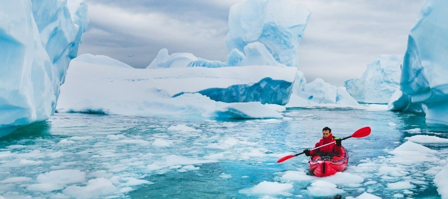 Kayaking amongst icebergs Antarctica